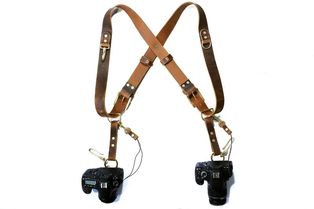 https://dmleatherstudio.com/cdn/shop/products/leather-dual-double-camera-harness-strap-for-two-camera-744512_1024x1024.jpg?v=1696127615